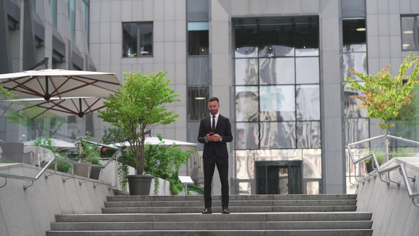 The man dancing on the stairs near the business center