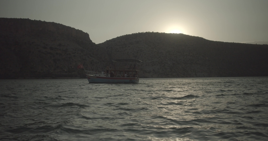 Boat with Turkish flags in Halfeti-Sanliurfa at sunset.