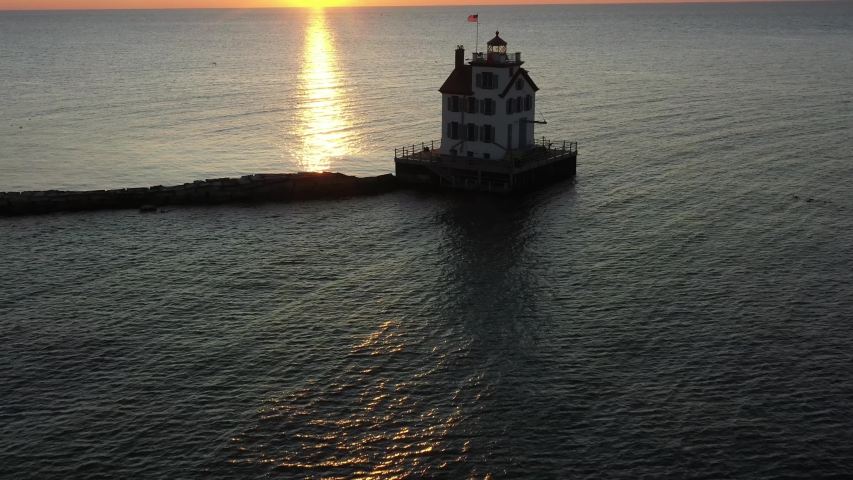 Lighthouse off the shore of Lake Erie during sunset