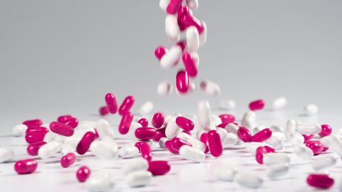 Colorful licorice candy falls in slow motion and bounces on a white background