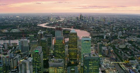 Aerial view of Canary Wharf skyline. London’s financial district with its modern skyscrapers. River Thames, famous bridges and buildings in the background. England. UK. Shot on Red Weapon 8K.