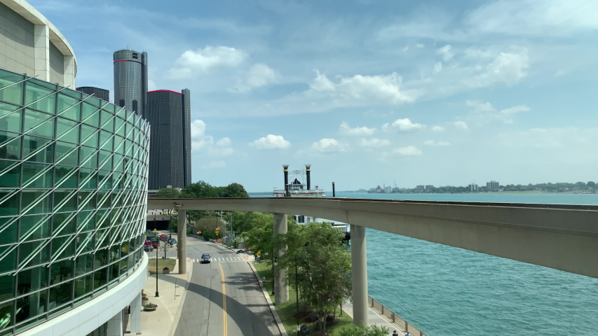 Aerial Drone Footage of Woodward Ave Detroit. Detroit skyline and traffic visible on a beautiful sunny day. Public transportation, and people walking by on the city streets.