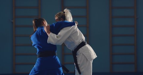 Fighter makes a throw through the hip, a fight on the tatami. Sparing judokas.