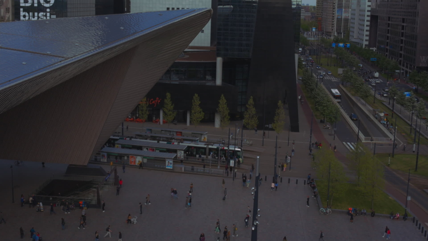 High shot of tram arriving at Rotterdam Centraal station downtown central business area in rush hour