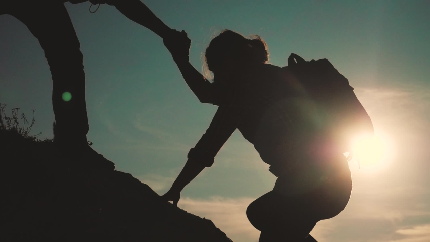 teamwork help business travel silhouette slow motion video concept. Helping hand silhouette between two climbers. teamwork group of tourists lends a helping hand climb the cliffs mountains. couple man Royalty-Free Stock Footage #1038607763