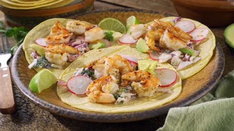 Delicious grilled shrimp tacos garnished with cilantro.
