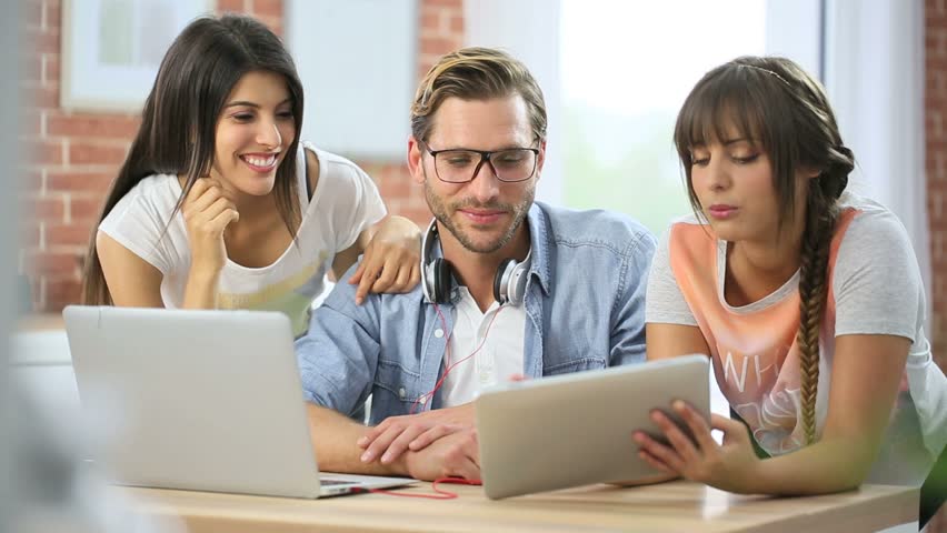Group of friends connected together on laptop and tablet | Shutterstock HD Video #10386185