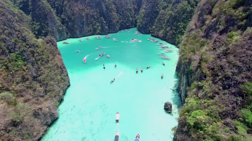 Aerial view of iconic tropical turquoise water Pileh Lagoon surrounded by limestone cliffs, Phi Phi islands, Thailand Royalty-Free Stock Footage #1038621764