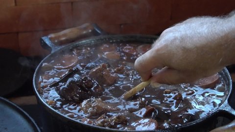 The national dish of Brazil - "Feijoada" being prepared in a cast iron pot. 