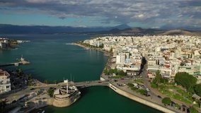 Aerial drone video of famous town of Halkida or Chalkida featuring old bridge connecting Evia island with mainland Greece with beautiful clouds and deep blue sky