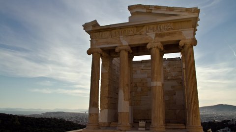 Time Lapse of the sun appearing behind the ancient temple of Athena Nike in the Acropolis in Athens, Greece