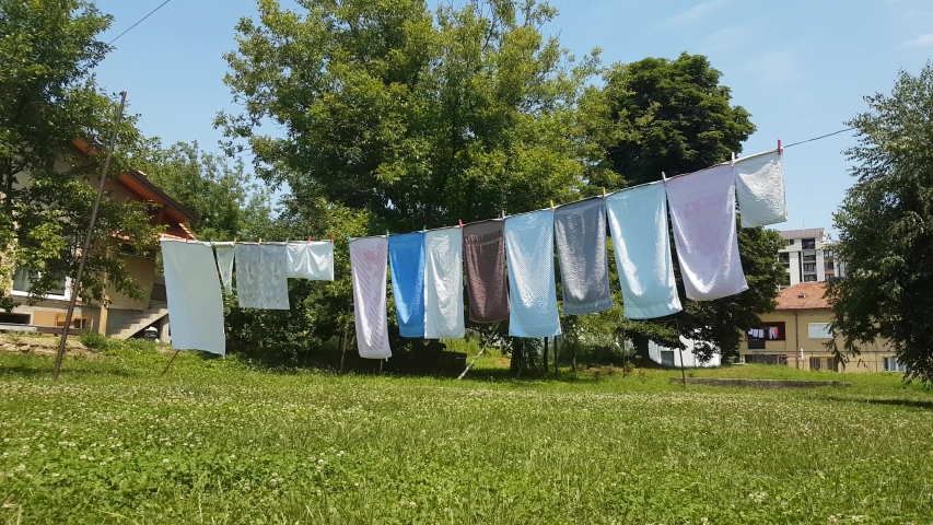Towels hanging and wind drying in the backyard over the grass