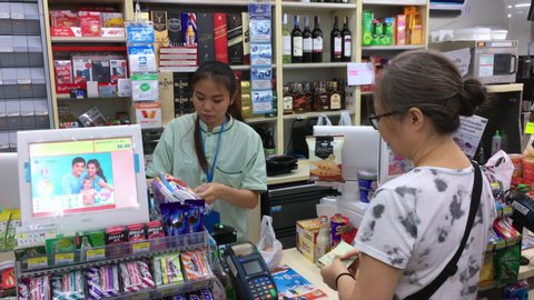 BANGKOK - SEPTEMBER 10, 2019: Unidentified young cashiers do their work at a store located by the Don Mueang airport.