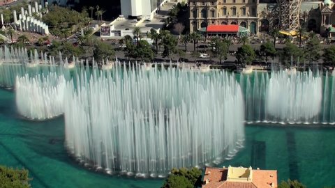 Las Vegas, Nevada, United States 8 october, 2019: luxury Bellagio fountains show on a sunny day with the Eiffel Tower in the background and blue sky. View of the Las Vegas Strip during the day.