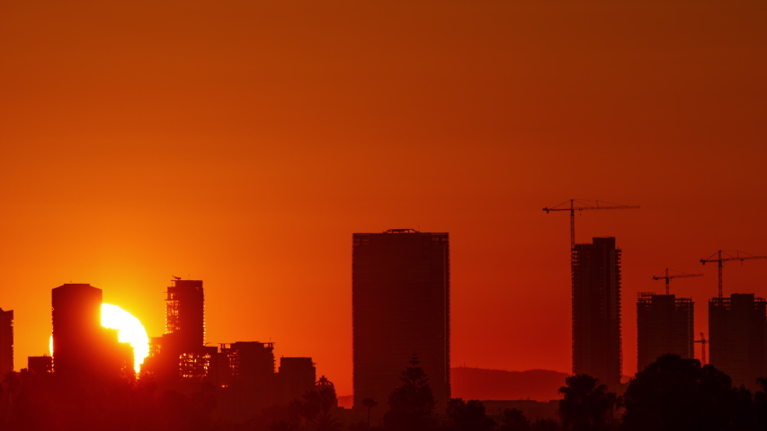 Time Lapse of the sun rising from behind downtown Los Angeles Royalty-Free Stock Footage #1038665609