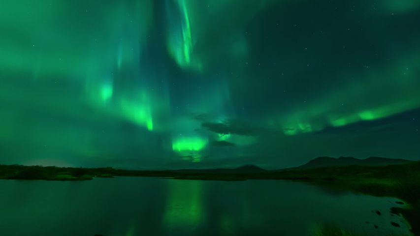 Aurora borealis reflecting in calm lake water Thingvellir Iceland.mov
 | Shutterstock HD Video #1038666155