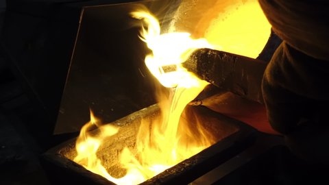 Yellow Hot Liquid Gold is Pouring From Huge Vessel to the Ladle for Gold Bar and Ingot Production, Induction Furnace