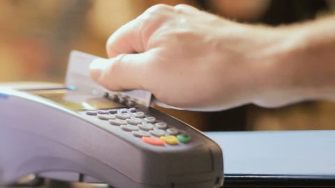 Credit card sale transaction, swiping card through terminal machine 