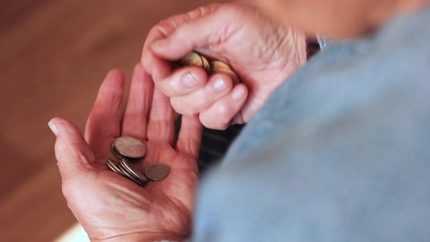 Coins in old granny hands close up. Poverty, Coins in hands close-up