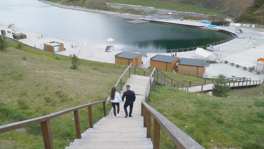 young couple descends on wooden gatherings