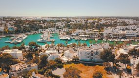 Aerial drone shot, island 4k travel video. Eye view on the sea coastline with pier and yacht at sunny day. Travel, journey, islands, Seascape, freedom, holidays concept
