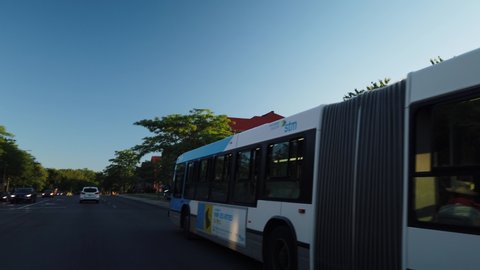 MONTREAL, CANADA - JULY 2019: Smooth and steady slow motion driving shot of a public bus STM