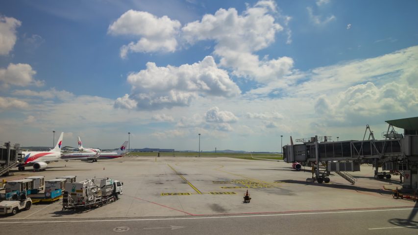 sunny day kuala lumpur airport aircraft parking window panorama 4k timelapse malaysia