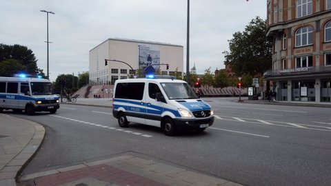 Hamburg, Germany - September 20, 2019: a platoon of police cars driving down Ballindamm surveying a Fridays for Future demonstration