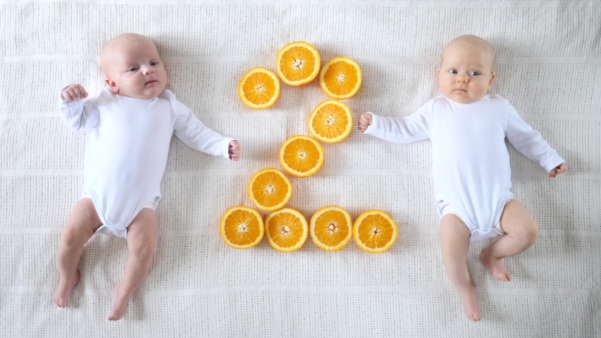 Cute Twin Two Months Babies In White Bodysuites