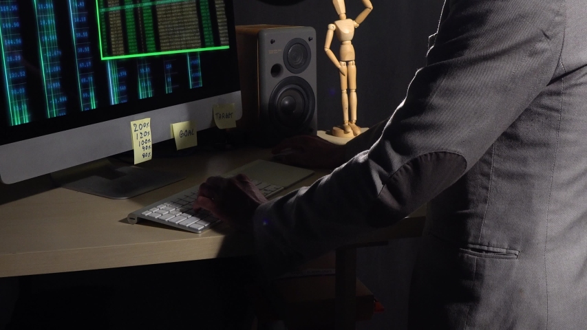 Young business owner sit in front of computer screen to checks and analyze market data as he tries to meet target goals