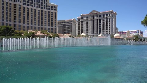 LAS VEGAS. USA - MAY 28. 2018 : Fountains at Bellagio Hotel Casino in Las Vegas Nevada. beautiful fountains show performance under blue sky on summer day. modern city with skyscrapers in america