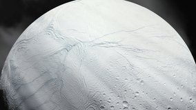 Enceladus, Moon of Saturn covered by clean Ice. Scientists think that the Ocean below Enceladus's surface could harbour the ingredients for Life. Elements of this video furnished by NASA. 