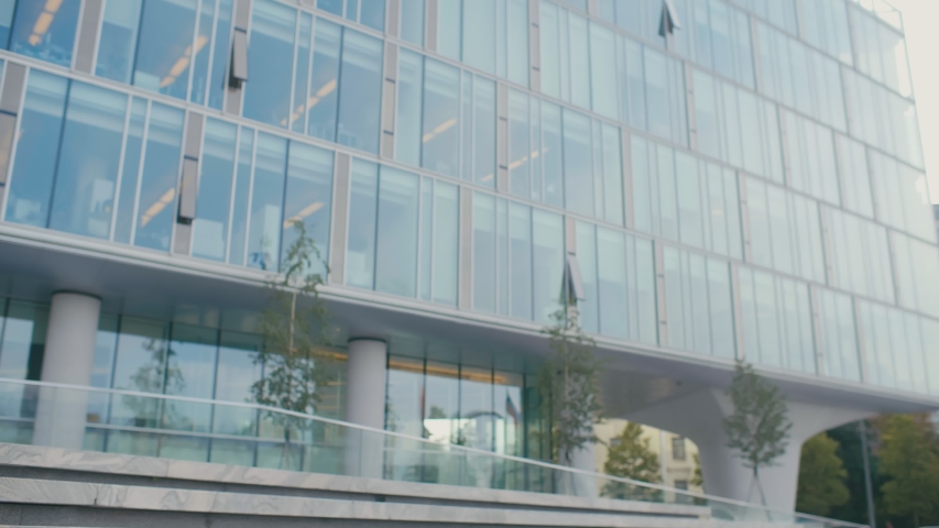 First day at new job concept, young happy confident businesswoman standing in front of modern glass office center near entrance, just hired smiling ready to start work in big company, motivational Royalty-Free Stock Footage #1038712718
