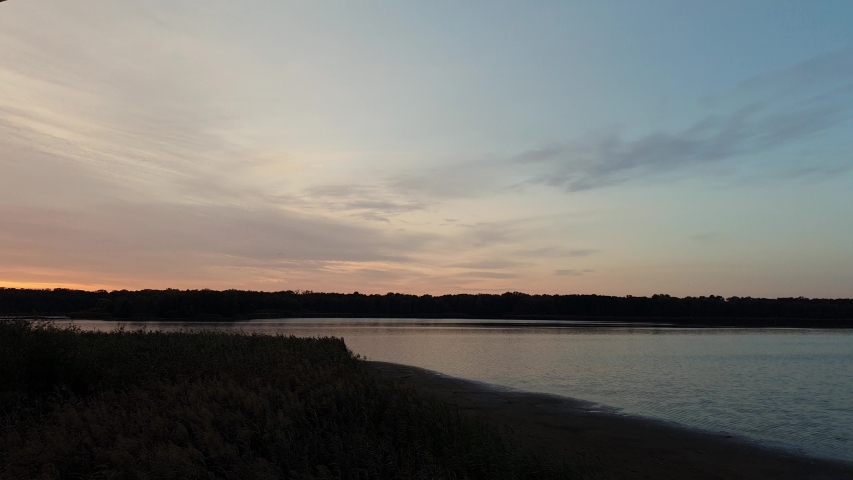 Landscape timelapse of beautiful after sunset sky over lake