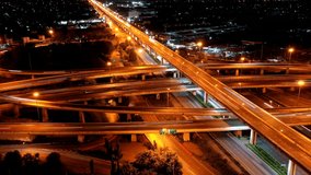 Aerial view of traffic time lapse on intersection circle. Busy traffic at night. Aerial view of road interchange or highway intersection with busy urban traffic speeding on the road at night. Junction - Powered by Shutterstock - Get 15% off with code: PIKWIZARD15