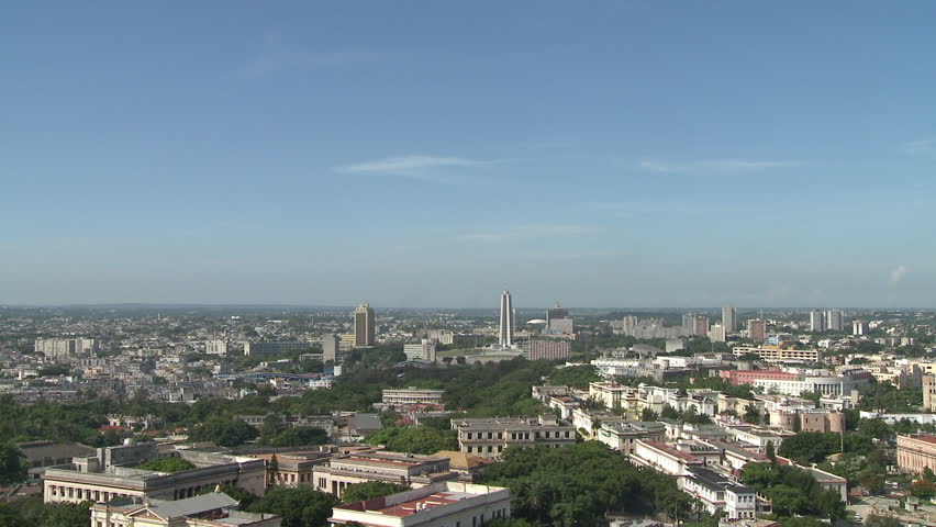 A wide, panoramic shot of Cuba, Havana. The camera pans from Plaza de la Revolucion (Revolution Square) and the Jose Marti Memorial across to the historical, central district of Havana.