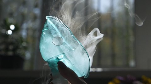 inhaler mask closeup with steam. Medical product. Cold treatment