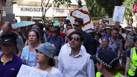 BRISBANE, AUSTRALIA - 20th September 2019 - Strike for Climate protestors march by committed to their cause climate action shutting down parts of the Brisbane CBD near the Queens Street Mall.