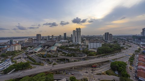 Aerial time lapse of Johor Bahru cityscape before sunset with busy traffic on elevated highway in South of Malaysia. 4KUHD.