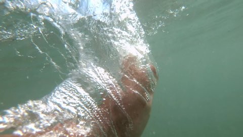 Slow motion bubbles ascending in ocean underwater