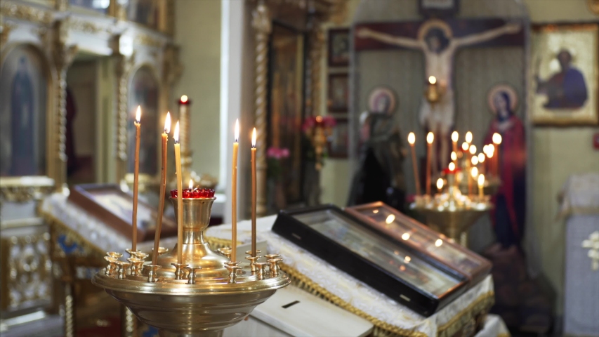 Close view of burning candles. Interior of beautiful russian church is on the background | Shutterstock HD Video #1038760568