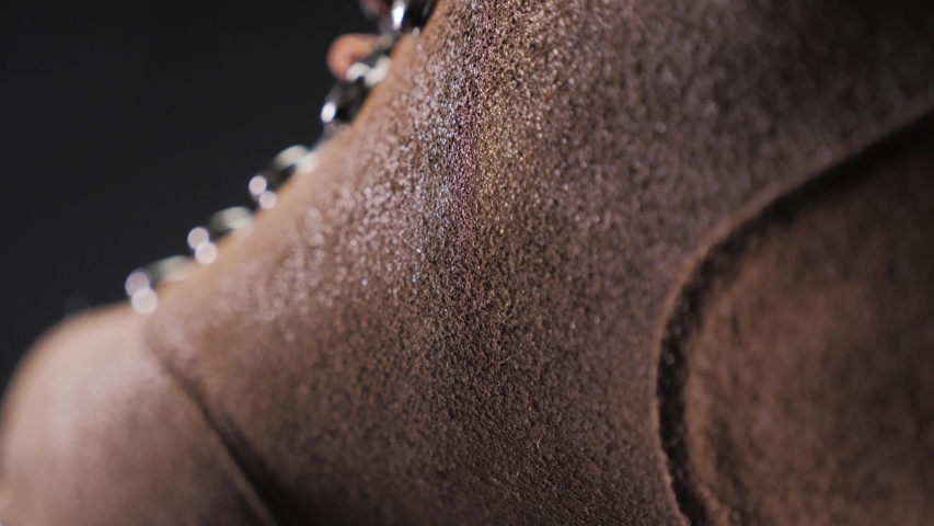 A waterproof spray is applied to the shoes