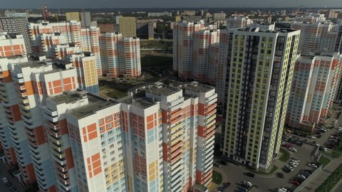 Modern large sleeping area residential complex with panel houses. New buildings apartments landscaping. Improvement development. Sunny day horizon Moscow Russia outskirts. Aerial forward