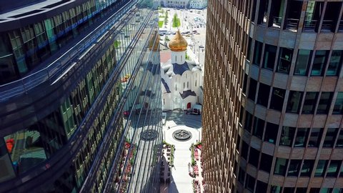 Aerial view of the church on sunny day background between two glass offices at Moscow Stock Video