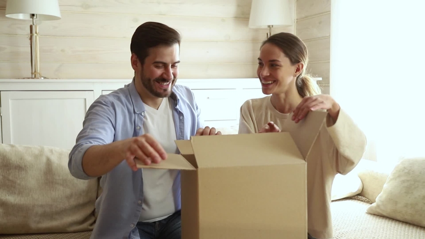 Happy couple customers open received parcel big carton box look inside feels dissatisfied with damaged broken package, angry spouses disillusioned wrong order, bad delivery service, refunding concept Royalty-Free Stock Footage #1038796148