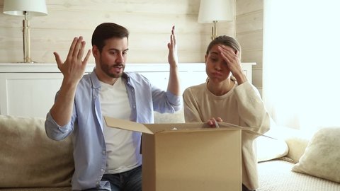 Happy couple customers open received parcel big carton box look inside feels dissatisfied with damaged broken package, angry spouses disillusioned wrong order, bad delivery service, refunding concept