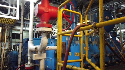 ABERDEEN, UK - JULY 07, 2019: Gimbal shot of triplex mud pumps for oil drilling rig in the pump room. A mud pump is one of the most important equipment on the rig.
