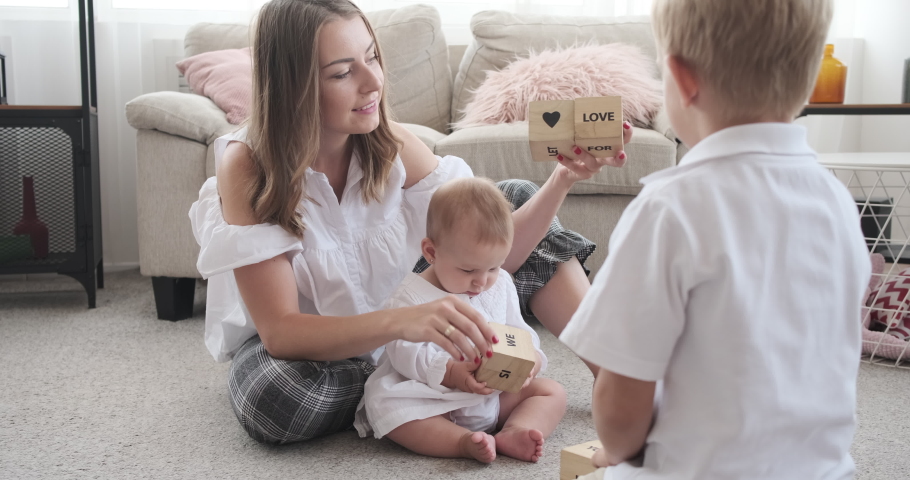 Family playing with wooden toy blocks at home