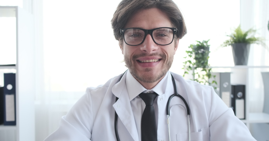 Smiling doctor with stethoscope at clinic