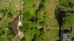 Aerial top view of  old fort surrounded by green trees and walking path